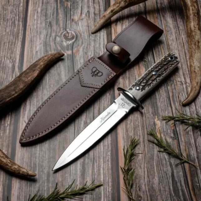 This knife features a 16.5cm blade and a polished stag handle, making it a reliable tool for various outdoor activities, especially boar hunting.